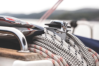 Close-up of coiled ropes on a classic sailboat deck