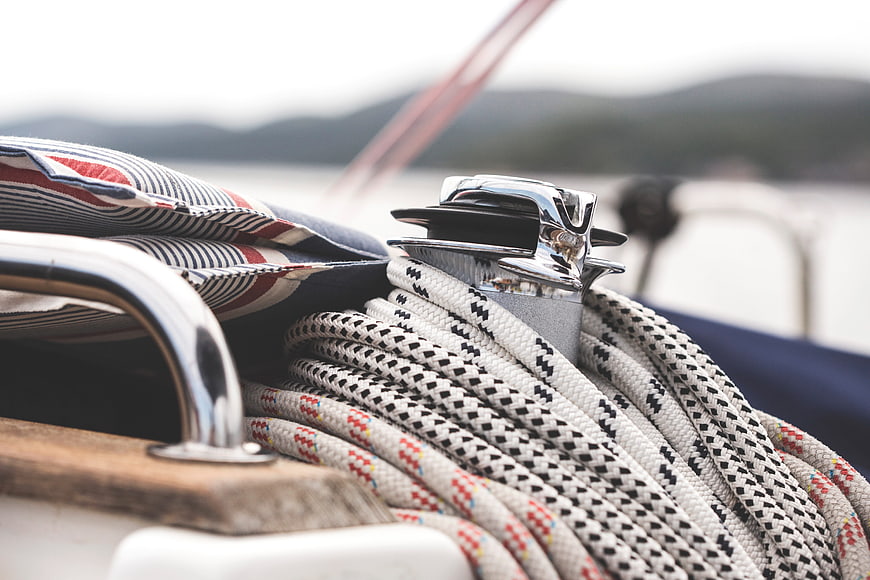 Close-up of coiled ropes on a classic sailboat deck