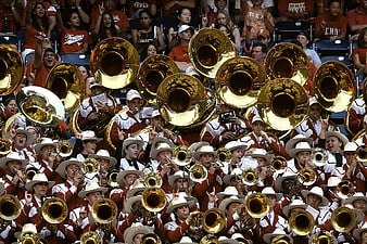 University Marching Band Playing Brass Instruments in Stadium