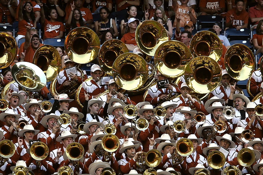 University Marching Band Playing Brass Instruments in Stadium