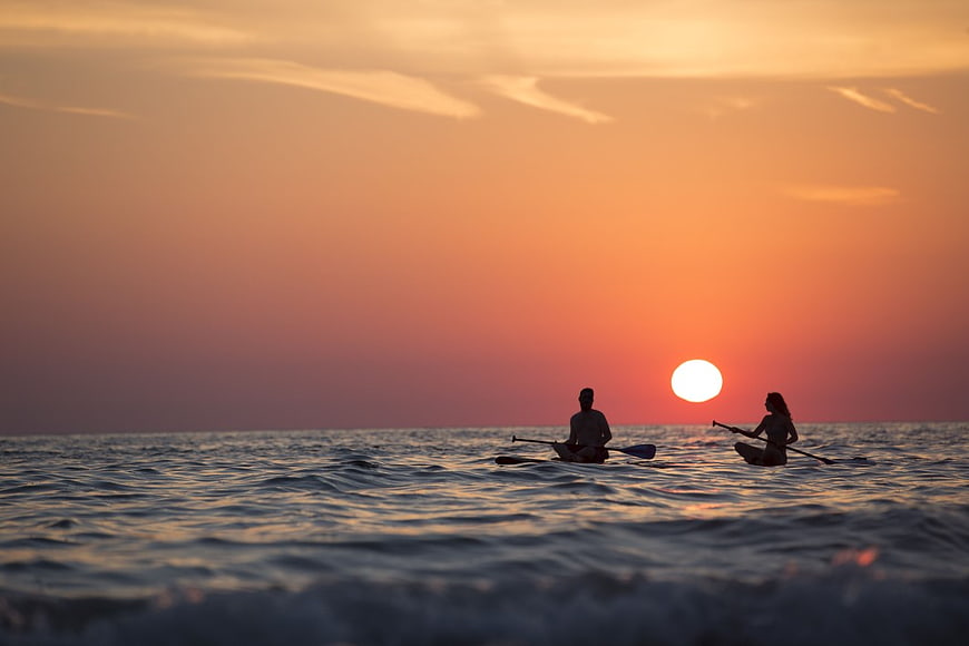 Couple Kayaking Silhouette at Golden Hour Sunset