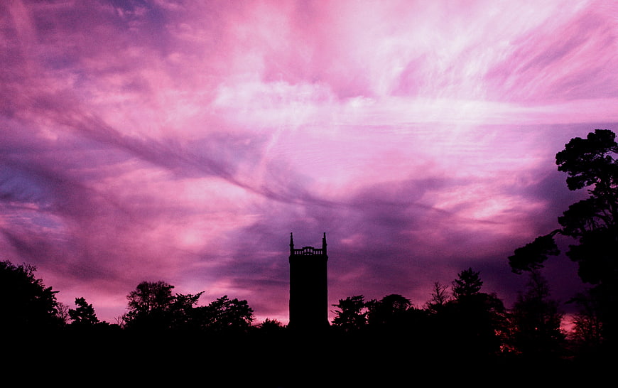 Silhouette of Church Tower Against Dramatic Pink Sky