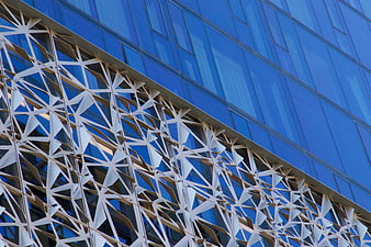 Modern Glass Building with Geometric White Facade Detail