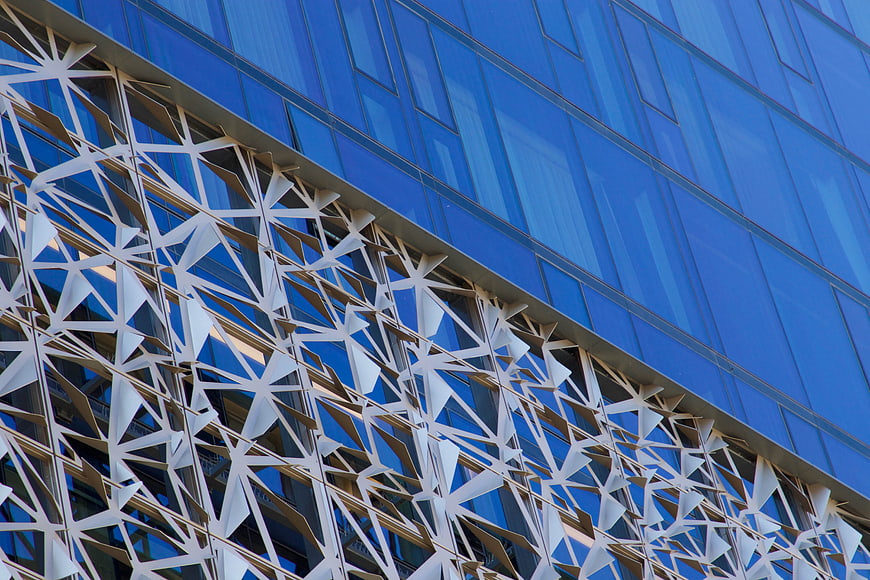 Modern Glass Building with Geometric White Facade Detail