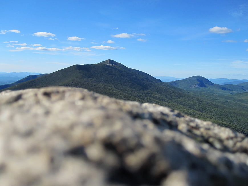 Scenic Mountain Landscape with Blurred Foreground Rock
