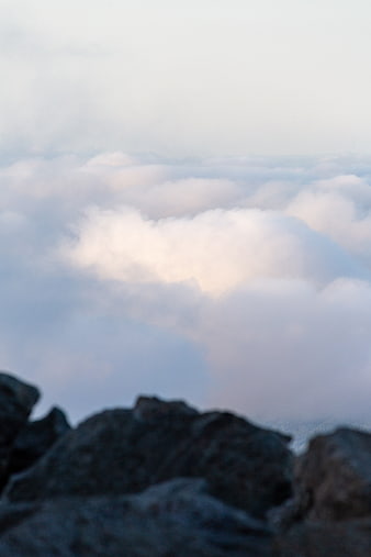 Soft Clouds Above Rocky Mountain Peak at Dusk