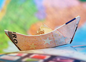 Origami Euro Banknote Boat on World Map Background
