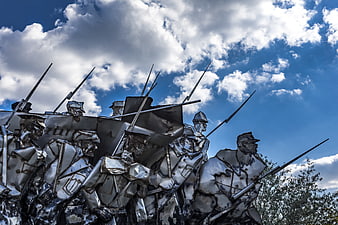 Soviet Military Monument Sculpture Against Dramatic Blue Sky