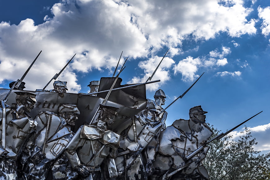 Soviet Military Monument Sculpture Against Dramatic Blue Sky