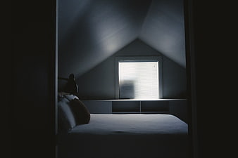Dark moody bedroom interior with window light