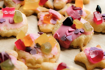 Colorful decorated cookies with jelly candies and heart sprinkles