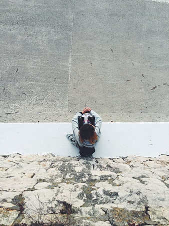 High angle view of woman sitting on white ledge