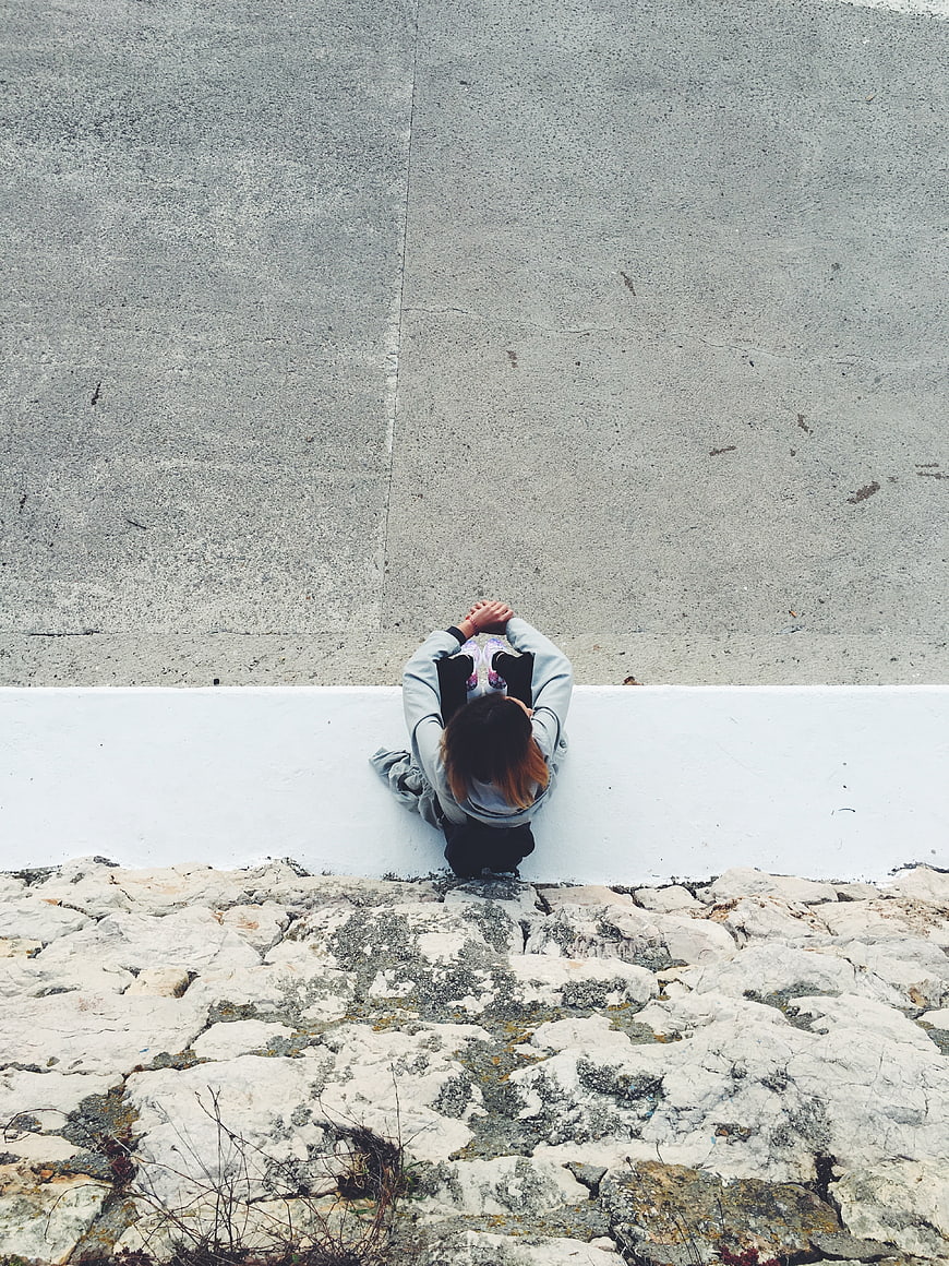 High angle view of woman sitting on white ledge