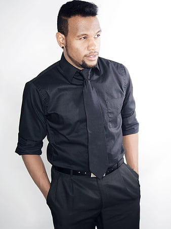 Confident Black Man in All-Black Business Attire
