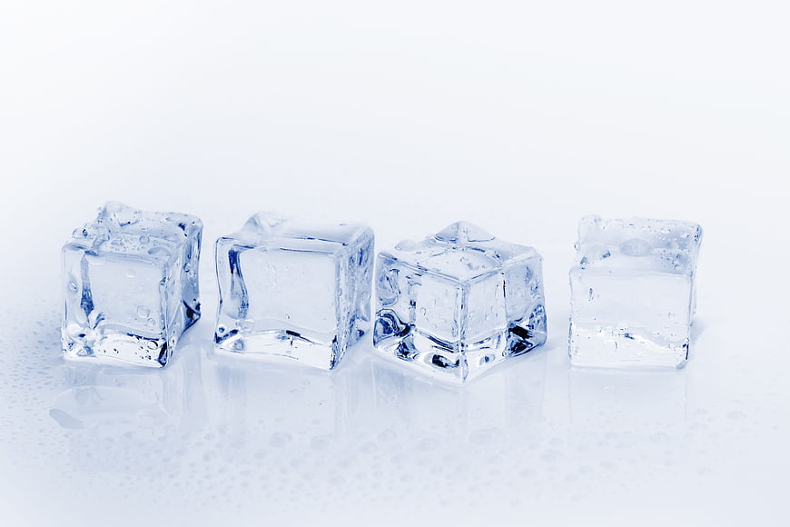 Four Clear Ice Cubes on White Background