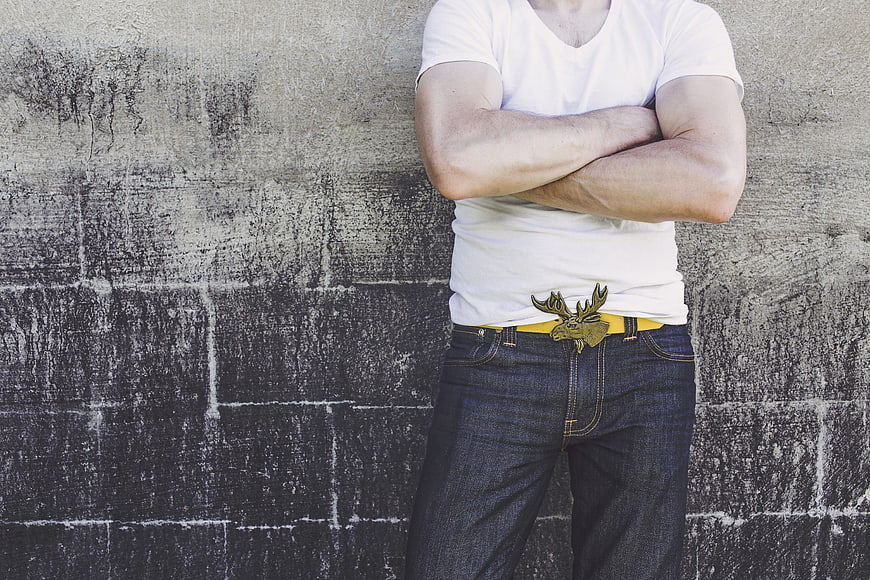 Man in white t-shirt and jeans with moose belt buckle