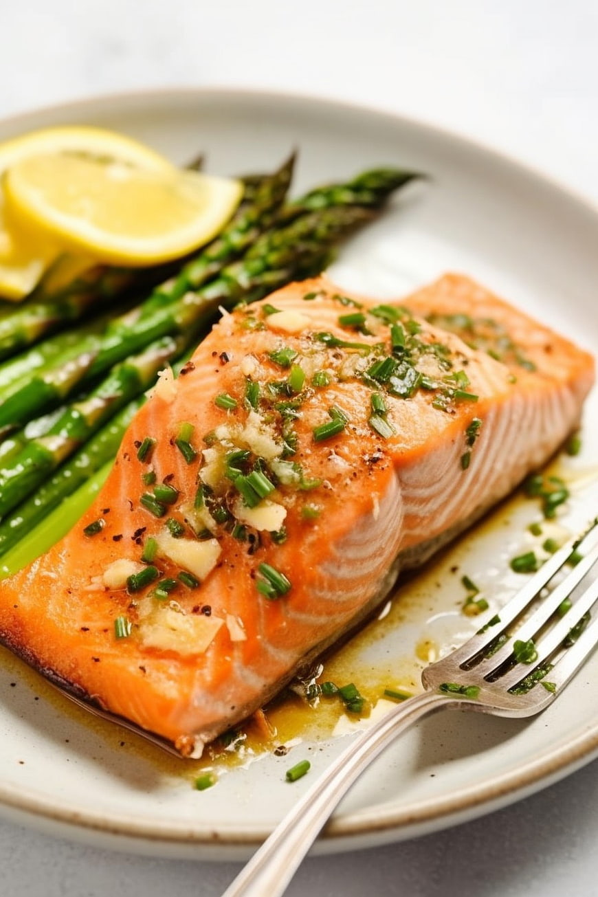 Grilled Salmon Fillet with Asparagus and Lemon on Plate