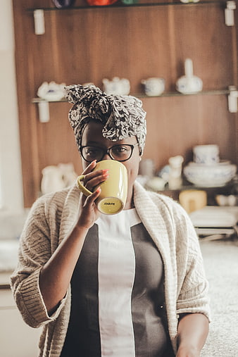 Woman with Headscarf Drinking Coffee in Kitchen