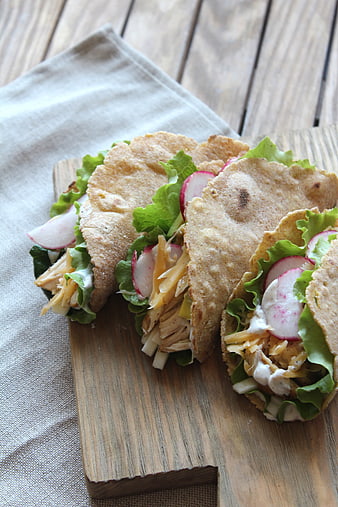 Fresh Chicken Tacos with Radish and Lettuce on Wooden Board