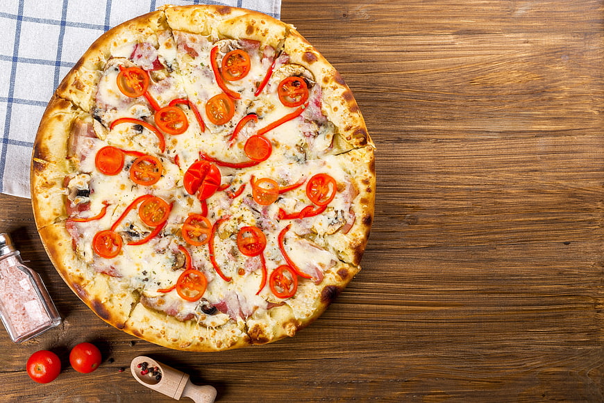 Top View of Homemade Pizza on Wooden Table with Ingredients