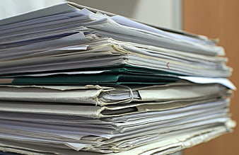 Close-up of a large stack of office documents and paper files