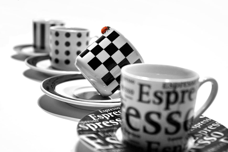 Black and white espresso cups with red ladybug