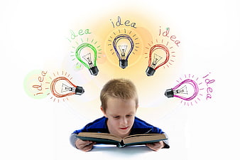 Young boy reading book with colorful lightbulb idea doodles