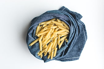 Top View of Penne Pasta in Blue Linen Napkin