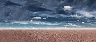 Vast Dry Desert Landscape Under Dramatic Cloudy Sky