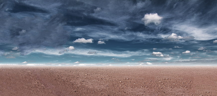 Vast Dry Desert Landscape Under Dramatic Cloudy Sky
