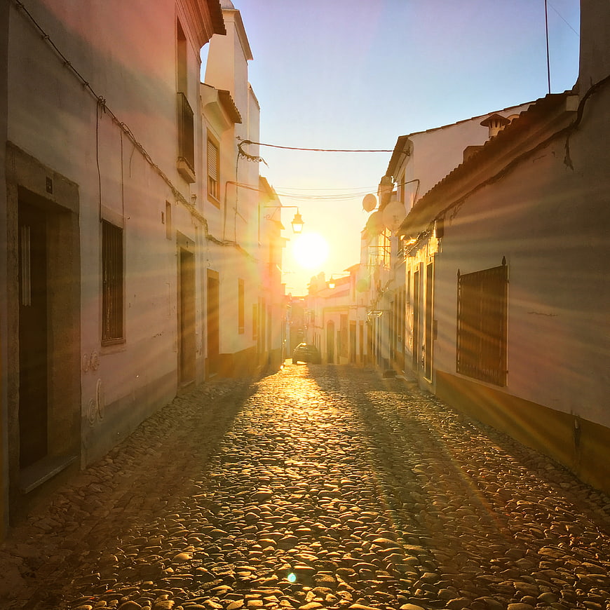 Golden Sunset on Narrow Cobblestone Street in Old Town