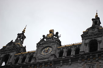 Low angle view of ornate grey architecture with gold accents