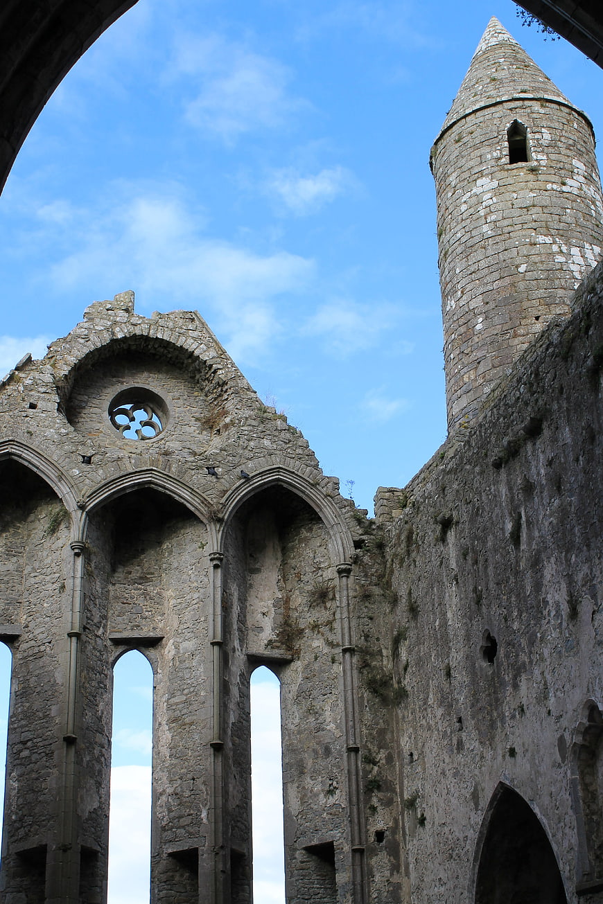 Ancient stone castle ruins with tower against blue sky