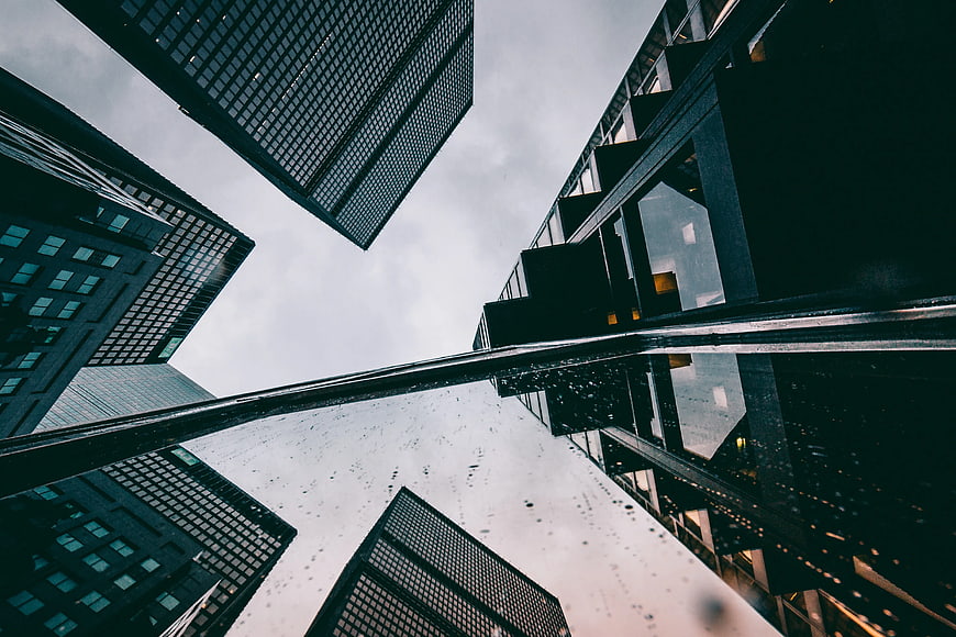 Low angle view of modern skyscrapers with rain reflection
