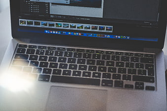 Laptop Keyboard with Photo Editing Software on Screen