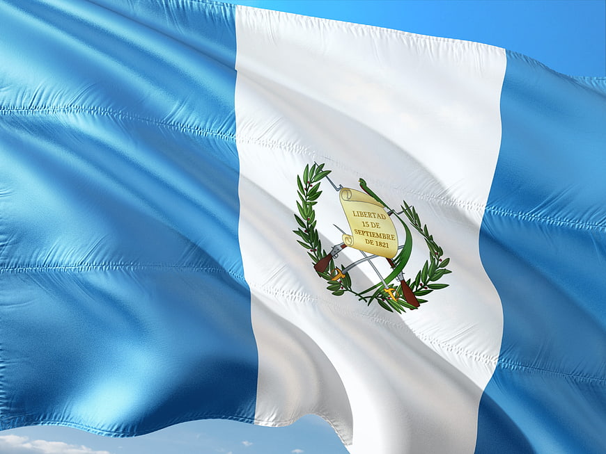 Guatemala National Flag Waving Against Blue Sky