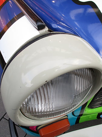 Close-up of vintage Trabant car headlight with colorful paint