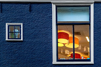 Blue Brick Wall with Large Window and Warm Interior Lights