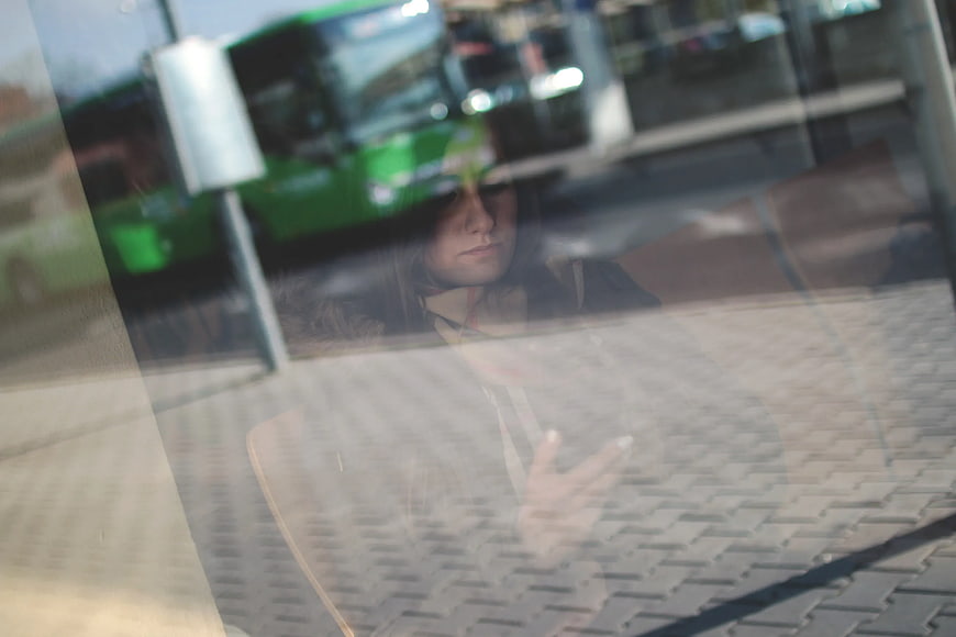 Woman Reflection in Glass Window with City Background