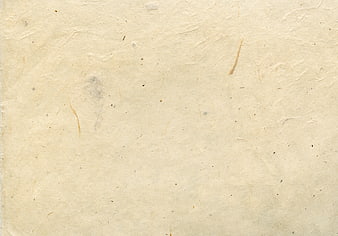 Textured beige handmade paper background with fibers
