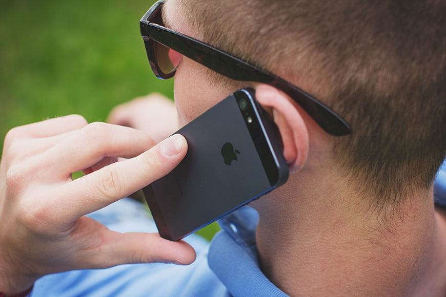 Close-up of man talking on smartphone with sunglasses
