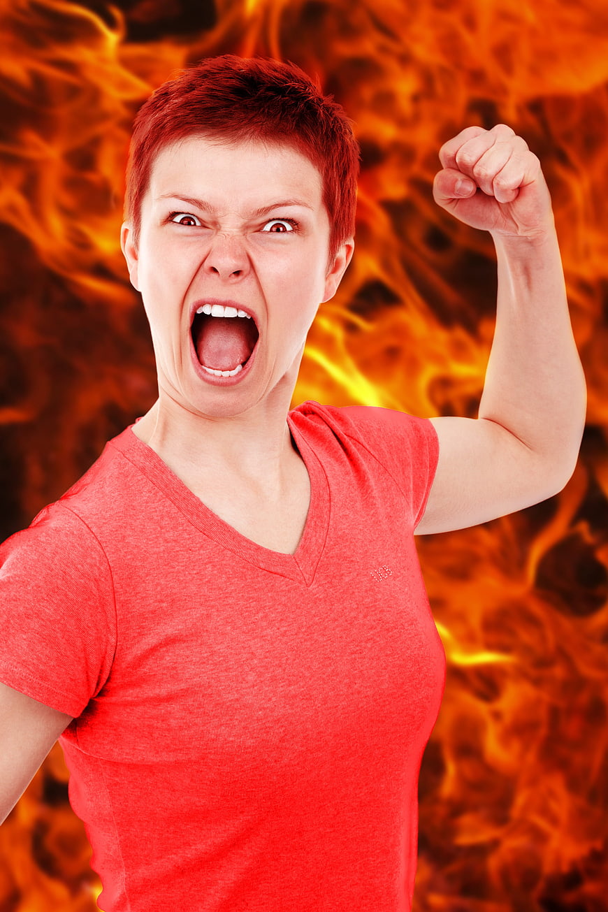 Angry woman screaming with fire background