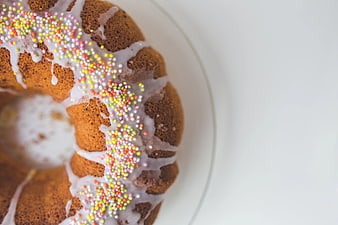 Top view of glazed bundt cake with colorful sprinkles