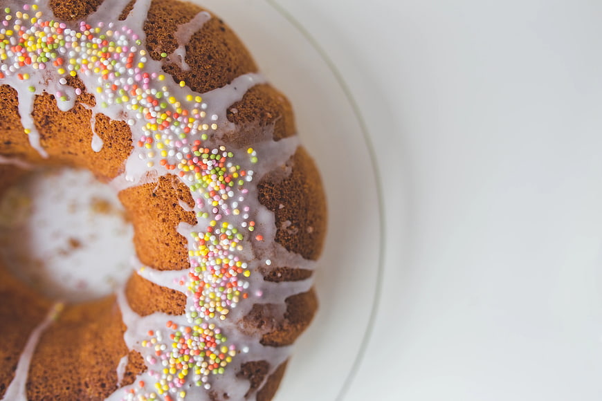 Top view of glazed bundt cake with colorful sprinkles