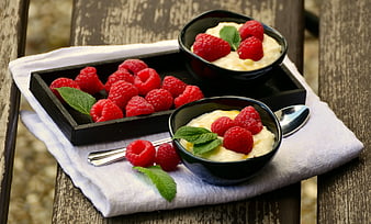 Fresh Raspberries and Cream Dessert on Wooden Table