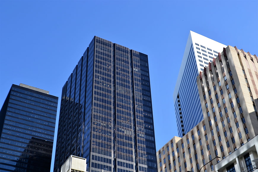 Low angle view of modern skyscrapers against blue sky