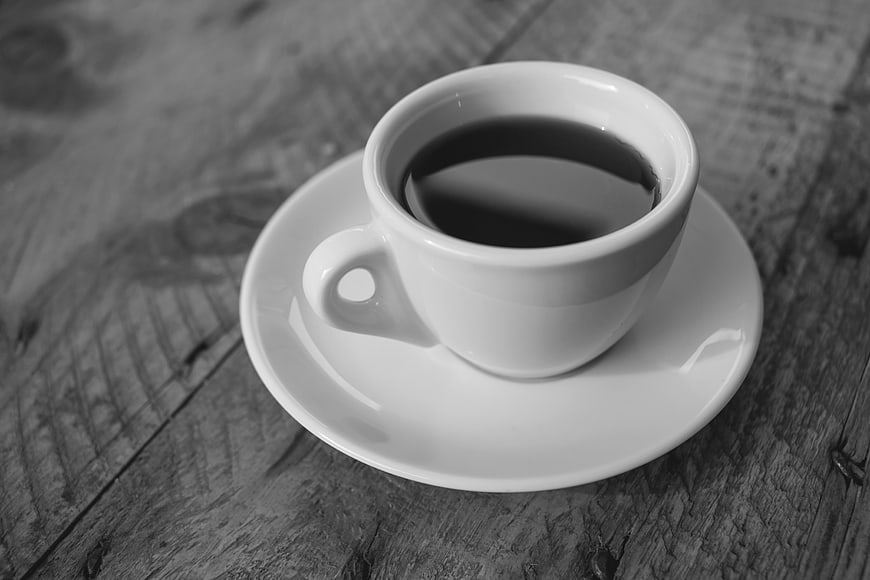 Black and white espresso cup on rustic wooden table
