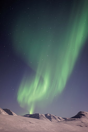 Green Aurora Borealis Over Snowy Mountain Landscape at Night