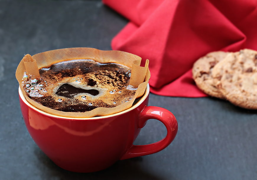 Red Cup with Coffee Filter and Cookies on Dark Slate