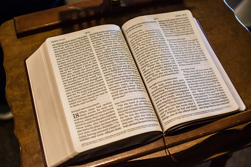 Open Bible on Wooden Stand with Warm Lighting